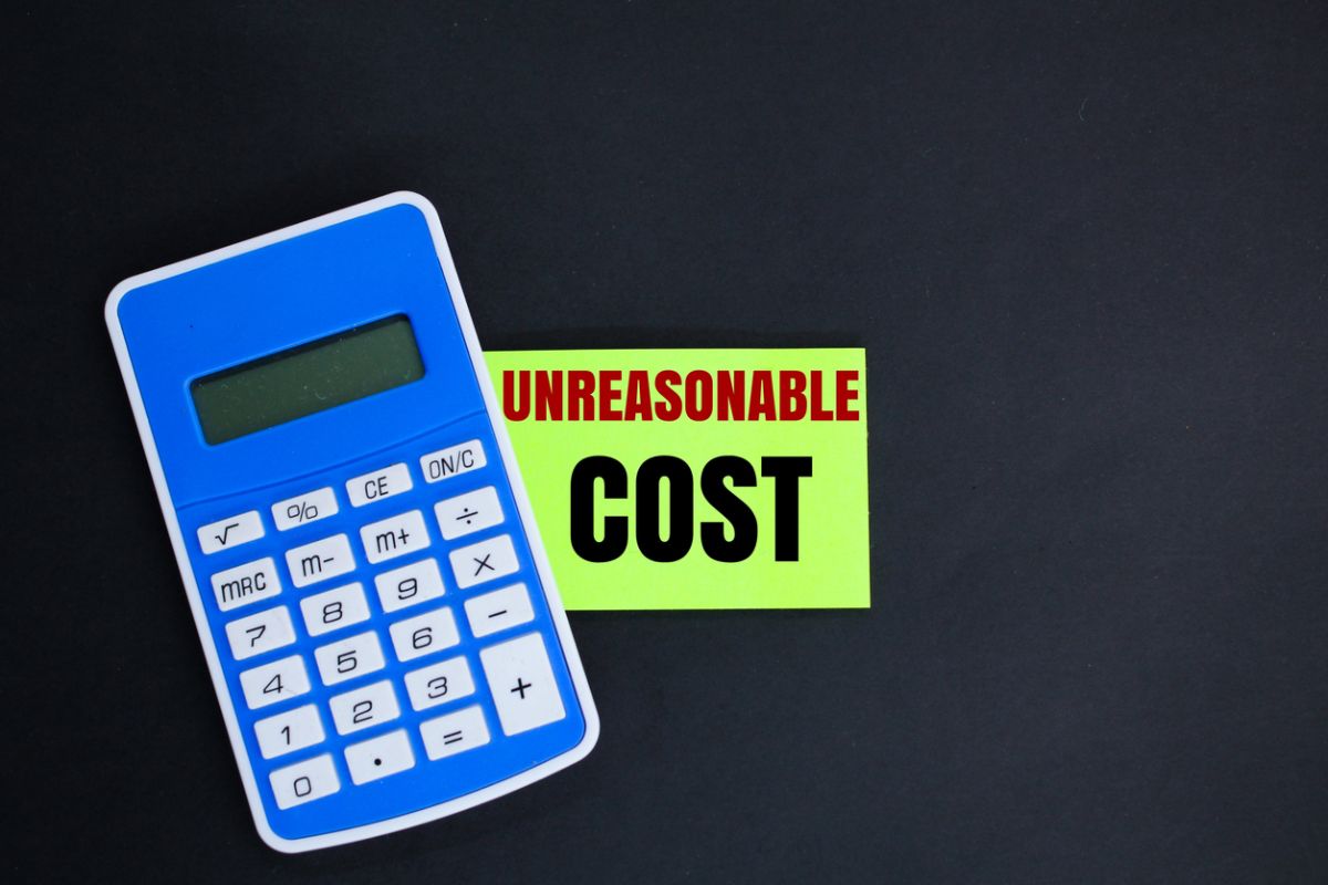Photo of calculator with post it note that says "unreasonable cost"
