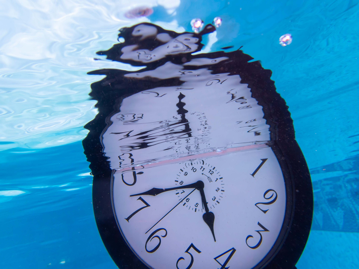 Clock in water blurred representing time travel